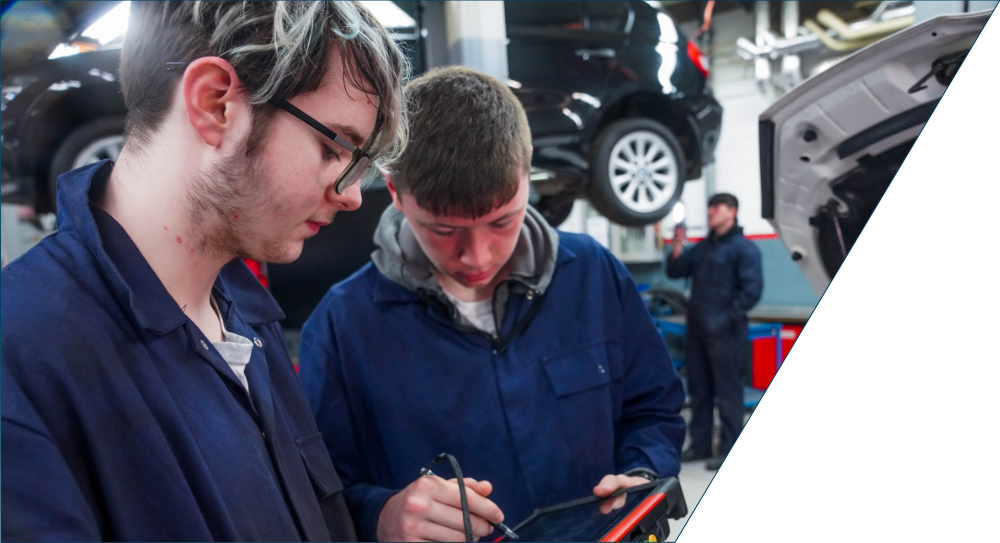 Two trainee's in motor vehicle workshop.